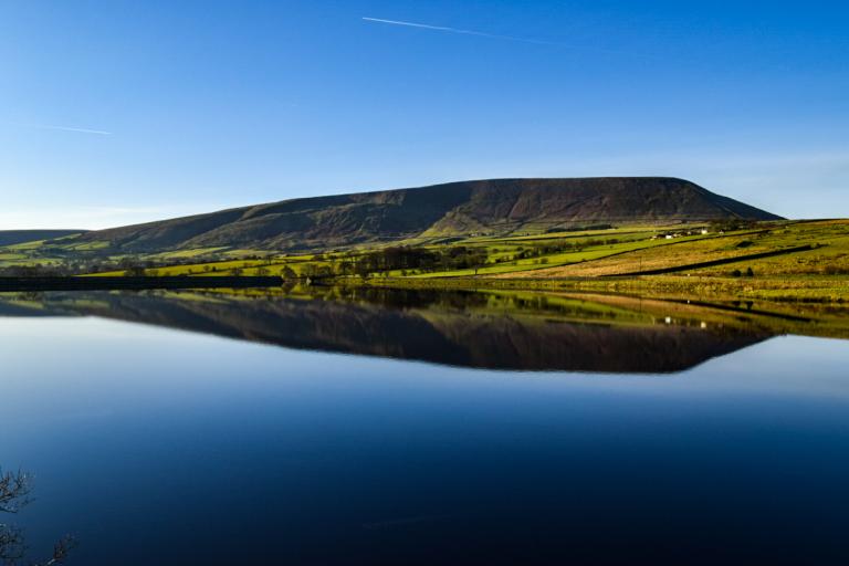 Pendle hill reflection in black moss